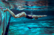 © BalanceFormCreative - Swimmer at the swimming pool.Underwater photo.