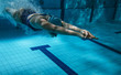 canvas print picture - Swimmers at the swimming pool.Underwater photo