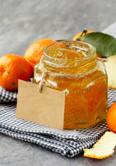 Poster - orange (tangerine) jam in a glass jar on the table