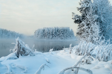 Wall Mural - Winter landscape, islands and shore unfrozen lake