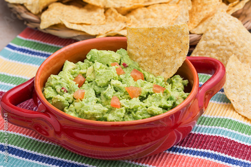 Fotografie, Obraz Chunky homemade guacamole in red ceramic dish