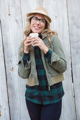 Poster - Smiling blonde in hat holding disposable cup