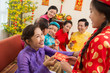 © DragonImages - Giving a red envelope for Tet