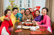 © DragonImages - Family at the Tet table