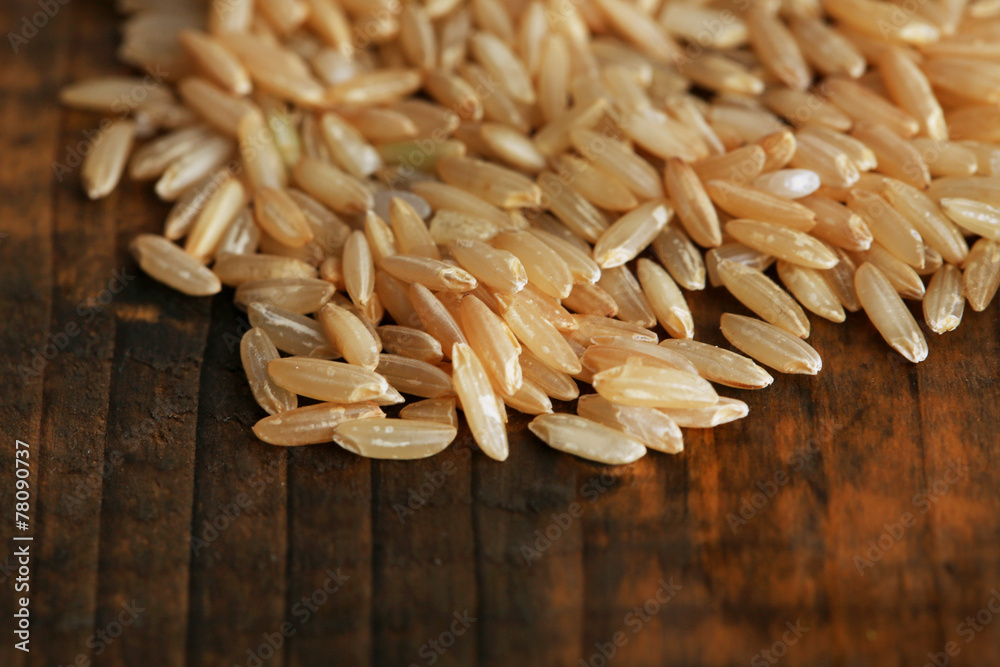 Rice grains on wooden background