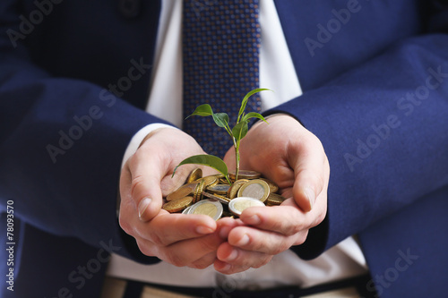 Cuadros en Lienzo Handful of coins with growing sprout, closeup view