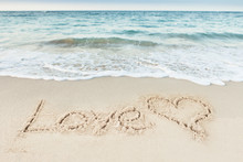 Love Text And Heart Drawn On Sand By Sea