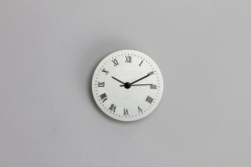 roman number clock surface on grey background