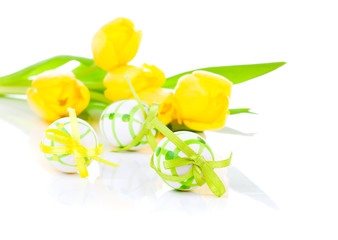 easter eggs with yellow tulip flowers isolated on white backgrou