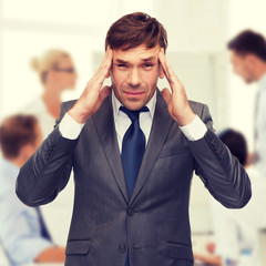 stressed buisnessman or teacher having headache