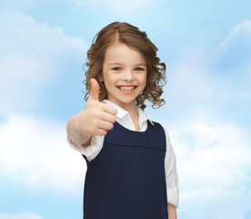 Wall Mural - happy little school girl showing thumbs up