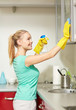 © Syda Productions - happy woman cleaning cabinet at home kitchen
