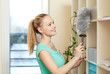© Syda Productions - happy woman with duster cleaning at home