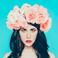 sensual brunette lady with floral wreath on her head. roses, spr