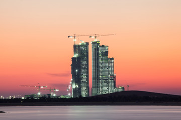 Fototapete - Construction site in Abu Dhabi at dusk. United Arab Emirates