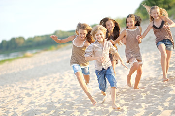 Wall Mural - Portrait of children on the beach in summer