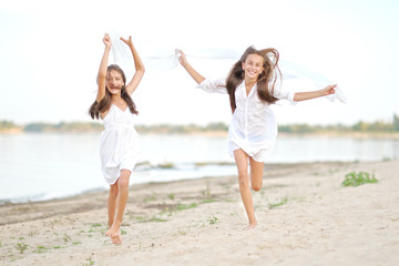 Wall Mural - Portrait of two girls on the beach