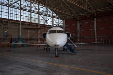 business jet airplane stays in hangar.