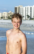 © travelview - handsome confident teenager in sunset at the beach