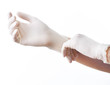 © Africa Studio - Doctor putting on sterile gloves isolated on white