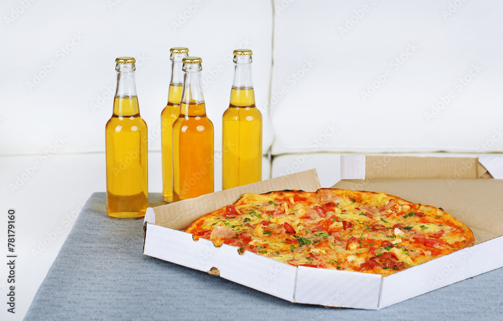 Table at home with pizza and drinks for friends