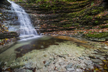 Waterfall in the forest in autumn, Monte Cucco NP, Umbria, Italy