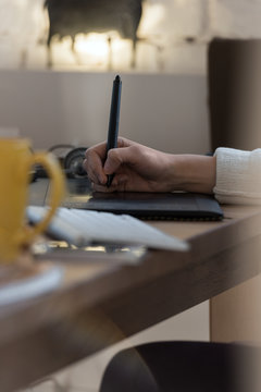 Graphic designer using digital tablet and computer in the office