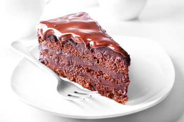 Poster - Delicious chocolate cake on plate on table on light background