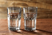 Two Glasses Of Water On Table On Wooden Background