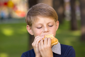 boy eating a hamburger