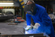 professional welder welding metal pieces in steel construction