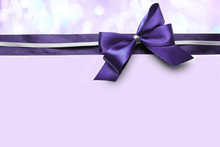 Color Satin Ribbon Bow On Purple Background
