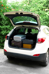 Wall Mural - Suitcases and bags in trunk of car ready to depart for holidays