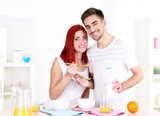 Fototapeta Panele - Happy couple has breakfast in kitchen