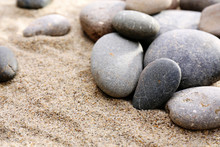 Gray Sea Pebbles On Sand Background