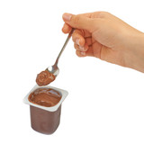 Fototapeta Maki - Spoon with chocolate pudding, coffee, baby food in hand on a whi