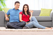 © Ljupco Smokovski - Couple posing seated on a carpet by a sofa at home
