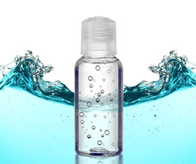 Wall Mural - Cosmetic liquid in vial on abstract water wave background
