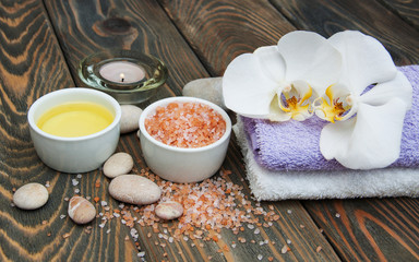 Poster - spa still life - a flowers  and towels  on a wooden background