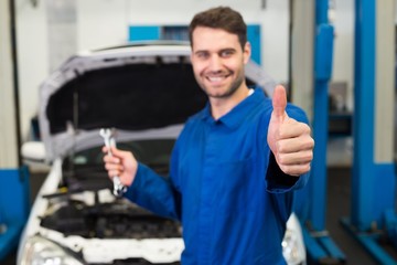 Poster - Mechanic holding pair of wrenches