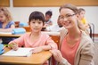 © WavebreakMediaMicro - Pretty teacher helping pupil in classroom smiling at camera