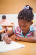 © WavebreakMediaMicro - Cute pupils writing at desk in classroom