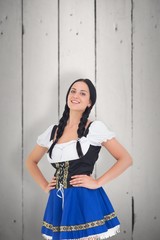 Wall Mural - Composite image of pretty oktoberfest girl smiling at camera