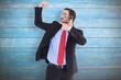 © WavebreakMediaMicro - Smiling man wearing a headset while pointing his bicep