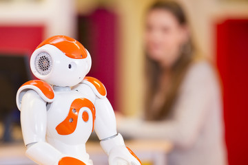 child playing and learning with robot