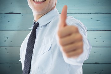 Poster - Composite image of businessman showing thumbs up