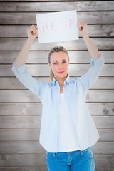 Poster - Composite image of pretty blonde holding help sign