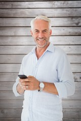 Poster - Composite image of smiling man sending a text message