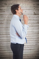Poster - Composite image of thinking businessman holding pen