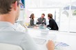 © WavebreakmediaMicro - Composite image of happy team laughing together at a meeting